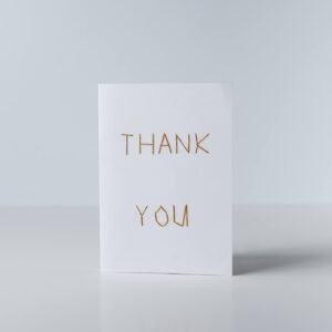 The words Thank you in Golden Brown thread, in simple stitching perfect for the blind.