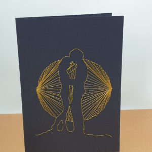 2023 Couple in the Glow of the Moon. This image is of a handcrafted greeting card which depicts a happy couple holding hands in the shadow of a full moon, hand stitched in glittery gold thread, on a black card.